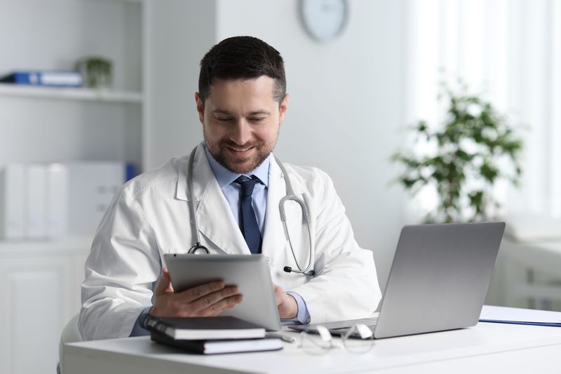 A physician in a clinic working with a tablet