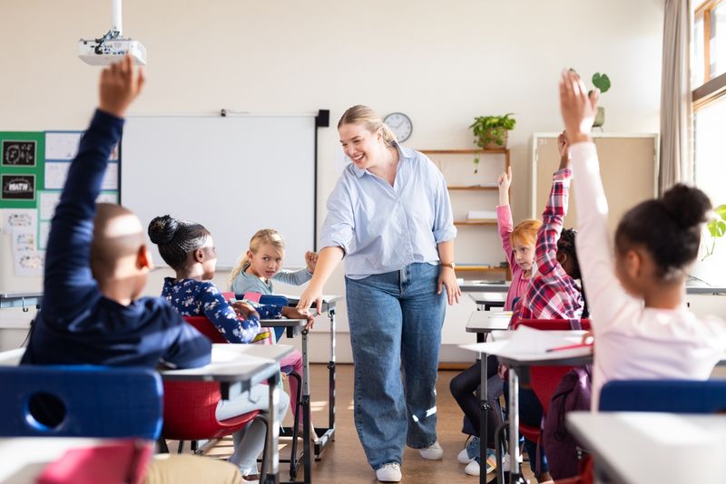 An educator in a classroom with an actively engaged group