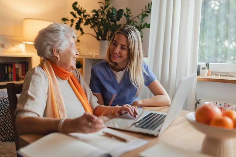 A therapist in conversation with a client at a computer
